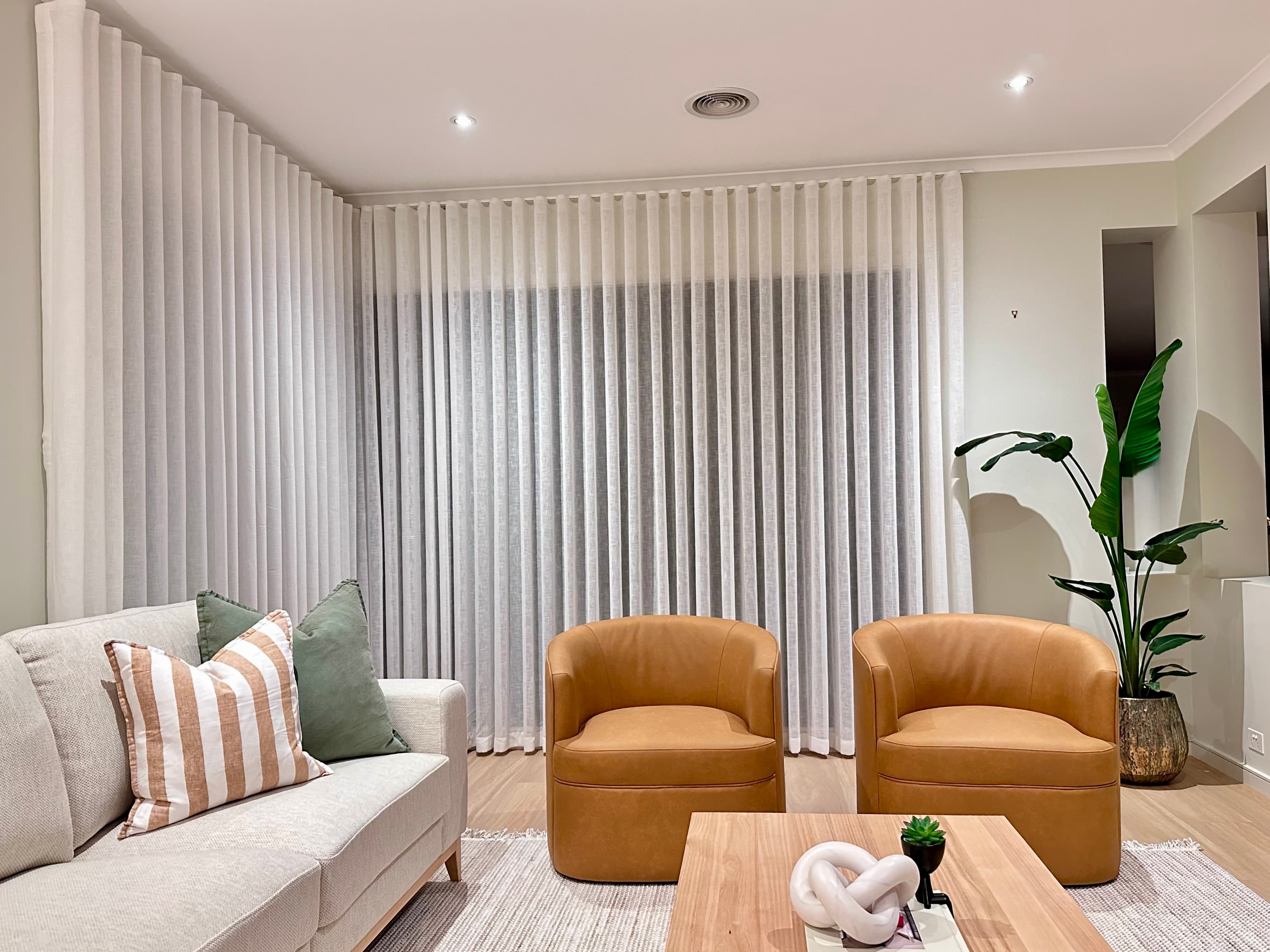 Floor-to-ceiling sheer curtains in a Sydney living room